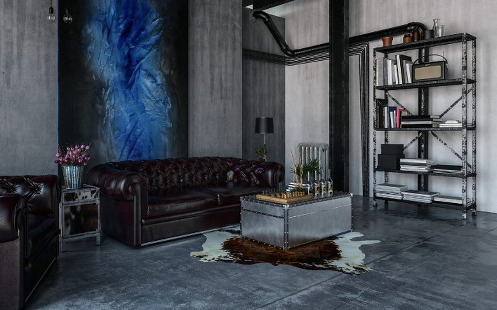 Local convertido en vivienda tipo loft con suelo continuo gris, sofá chester y estanterías de hierro